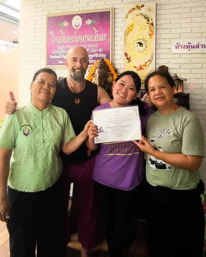 Thassiana Harumi com seus mestres na Tailândia, recebendo o certificado de Nuad Thai